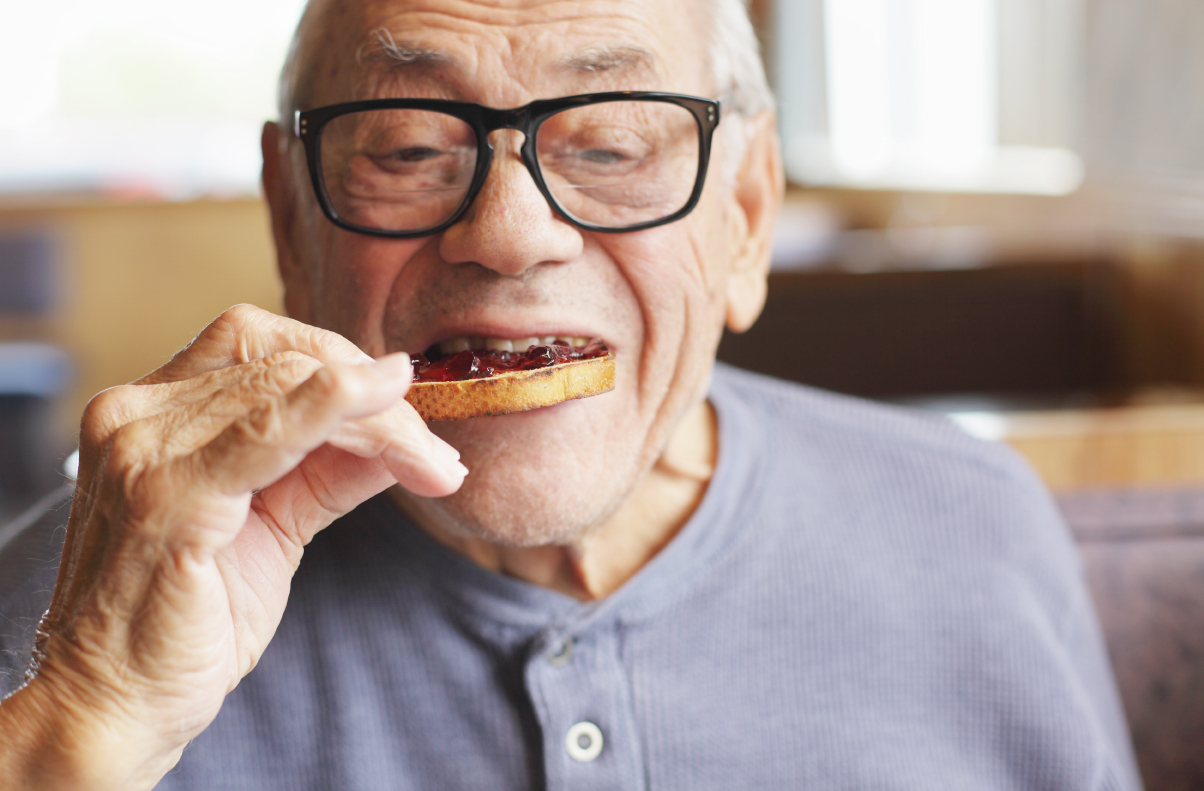 Senior Man Eating Toast and Jelly Jam